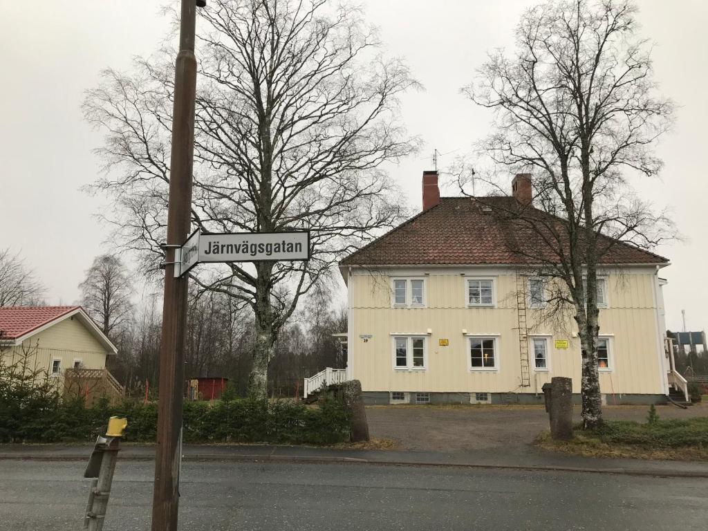 a street sign in front of a white house at Anki's apartment in Haparanda