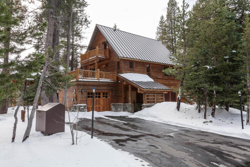 a log cabin in the woods in the snow at Meyer Mountain Home in Soda Springs