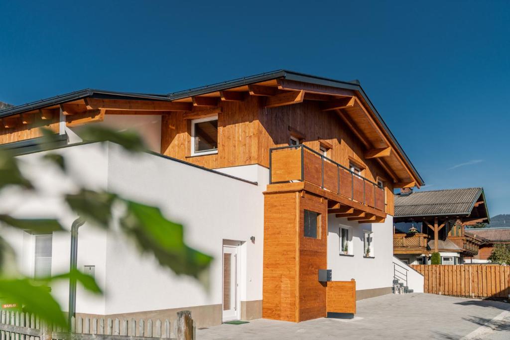 a house with a wooden roof at Schlicki´s Appartement in Flachau