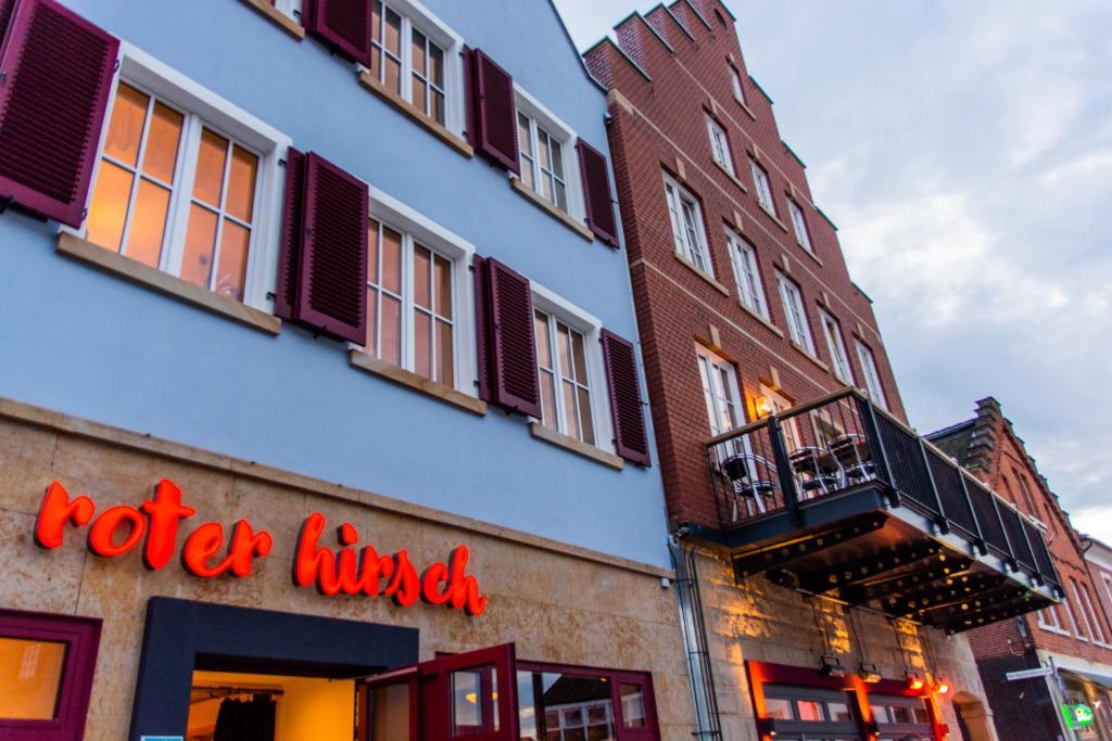a building with a red sign on the side of it at Appartement Backstage in Rheine