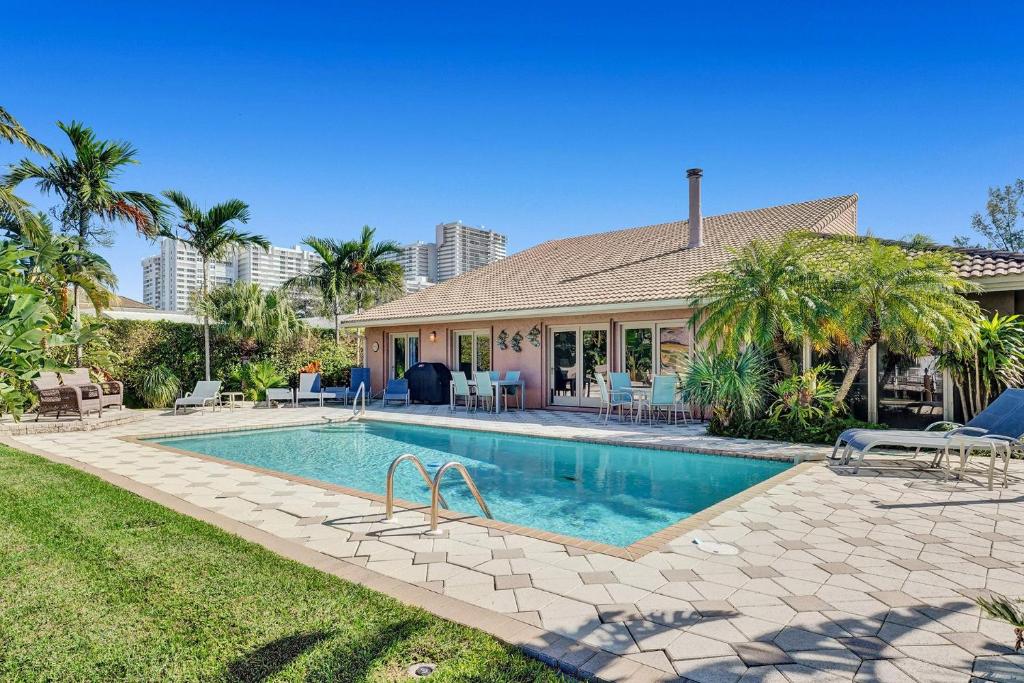 a house with a swimming pool in a yard at By the Sea Villa in Fort Lauderdale