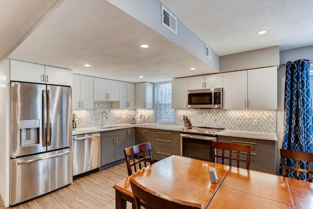 a large kitchen with a wooden table and a dining room at Mountainside #272H in Frisco