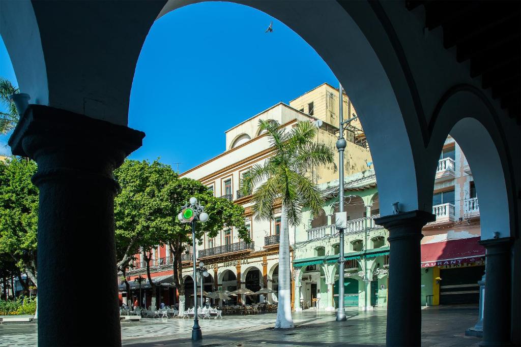 a view of a street with palm trees and buildings at Hotel Imperial in Veracruz