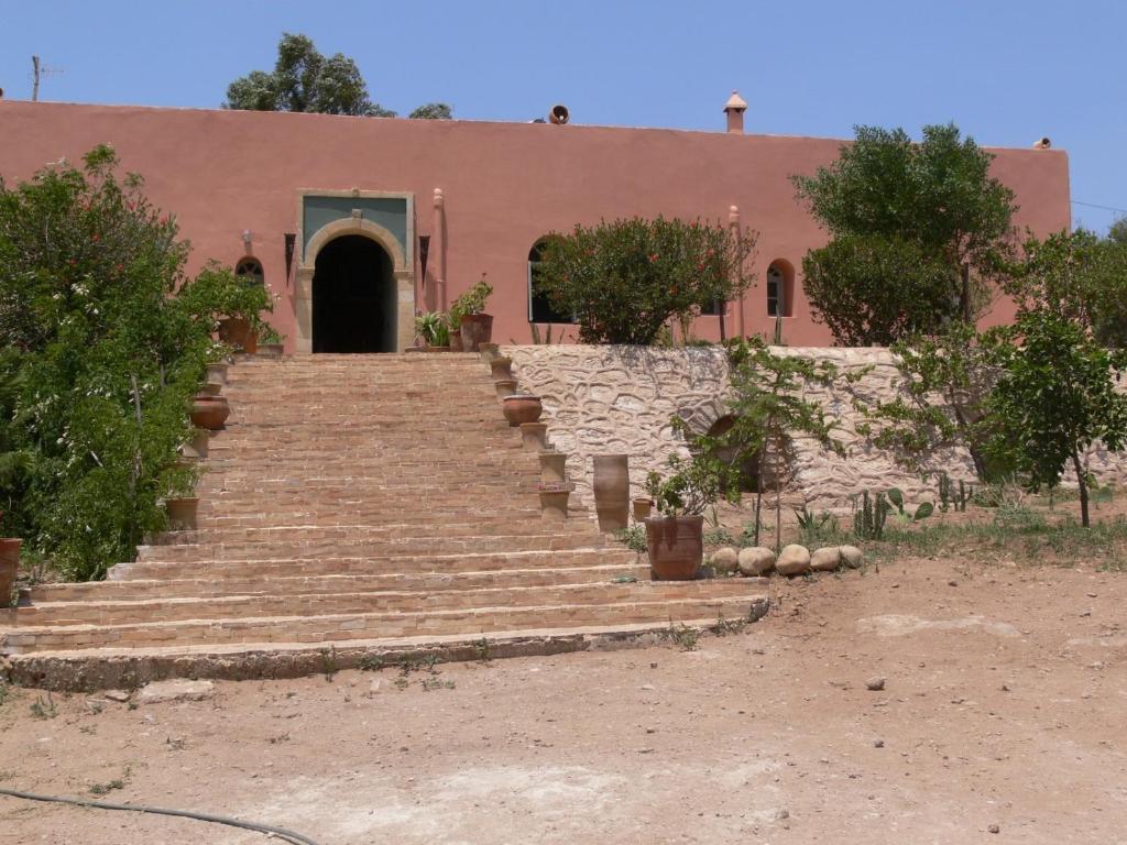 a building with stairs in front of a building at Riad Douar Des Oliviers in El Arba