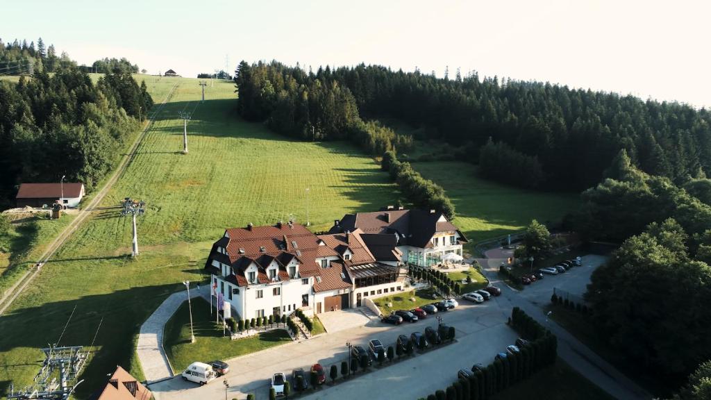 an aerial view of a large house in a field at Kompleks Beskid in Spytkowice