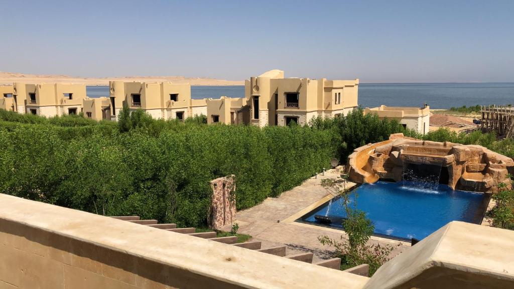 a view of a house with a swimming pool at Villa M45 Byoum- Fayoum in Qaryat at Ta‘mīr as Siyāḩīyah