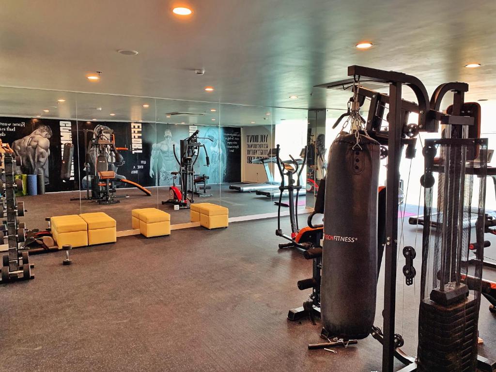 A spacious gym with cardio and strength-training equipment.