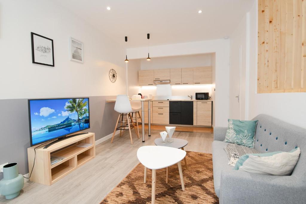 a living room with a couch and a tv at Roudadoux in Issoire