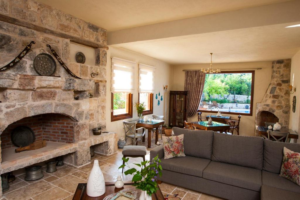 a living room with a large stone fireplace at Room in BB - Exclusive and Romantic Boutique Hotel in Fethiye