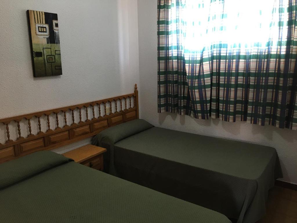 Postel nebo postele na pokoji v ubytování Bertur Peñismar