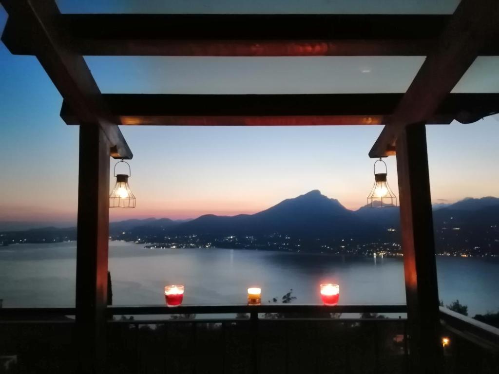 a view of a lake from a window with lights at B&B da Paolo con vista Lago di Garda in San Zeno di Montagna