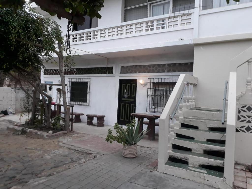 a white building with a staircase and a stair case at Suite frente a la playa in Playas