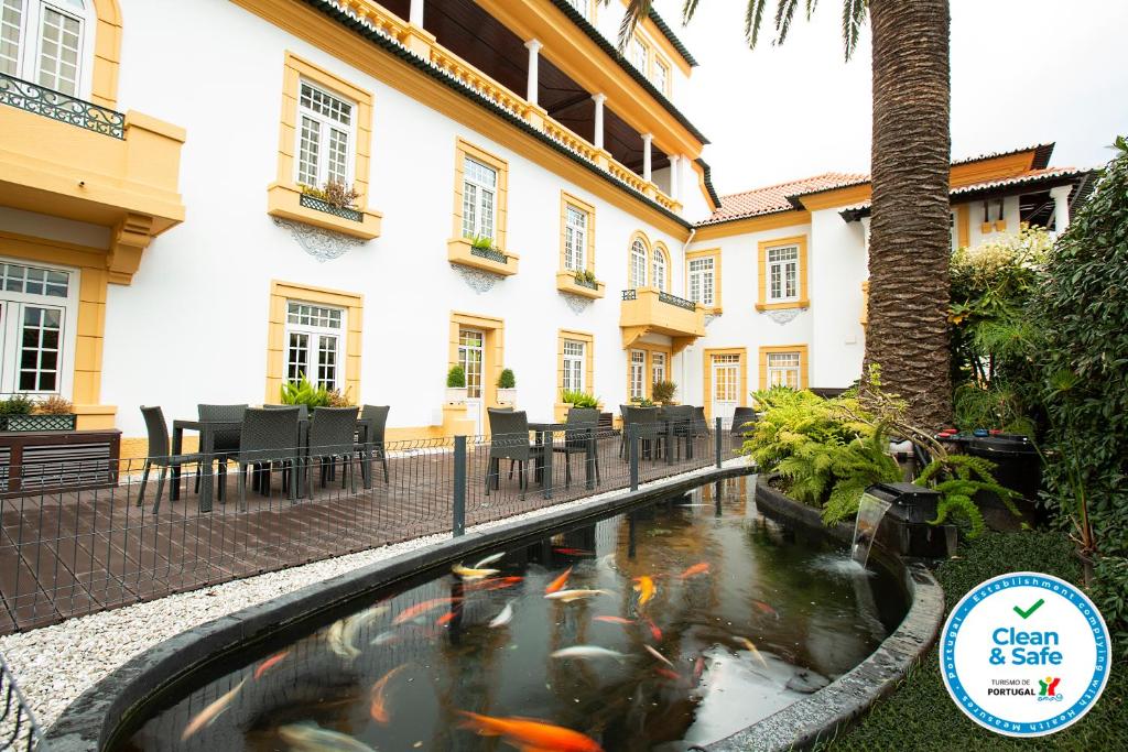a koi pond in the courtyard of a hotel at Veneza Hotel in Aveiro