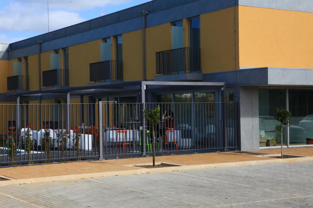 a building with a fence in front of it at Hotel 3K Faro Aeroporto in Faro