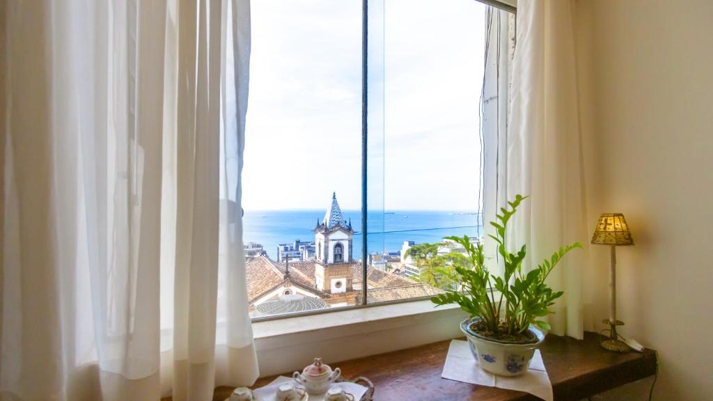 a window with a view of a church at Apartamentos Praça da Sé in Salvador