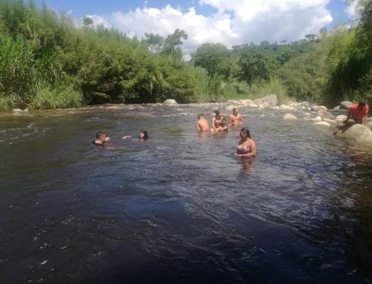 a group of people swimming in a river at Fonda la Legia in Los Andes