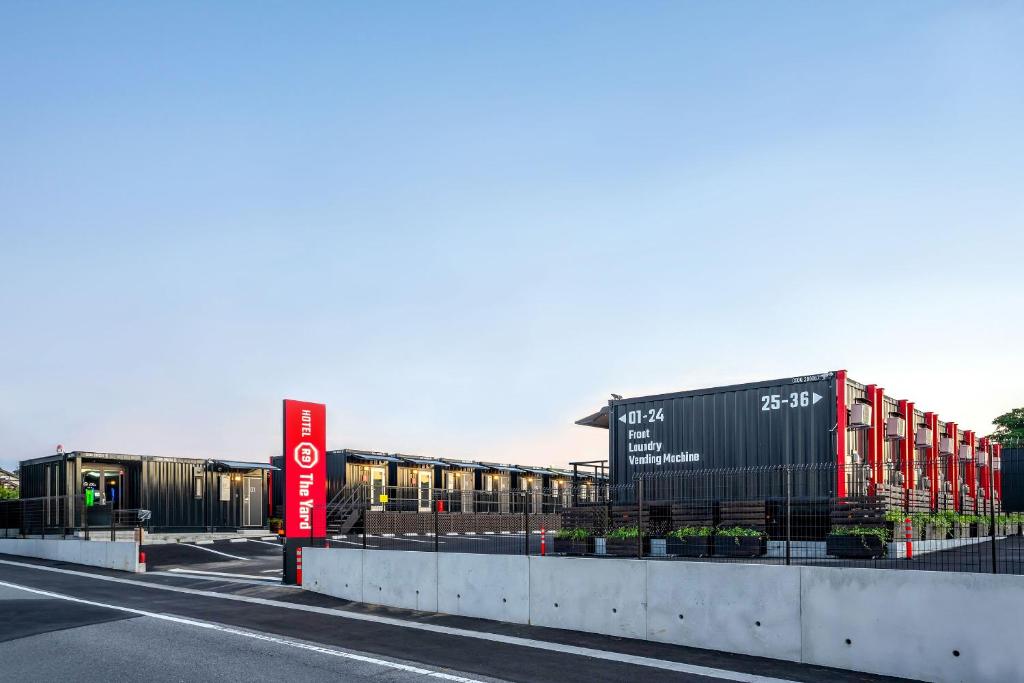 a street with a train on the side of a road at HOTEL R9 The Yard Isumi in Chōjamachi