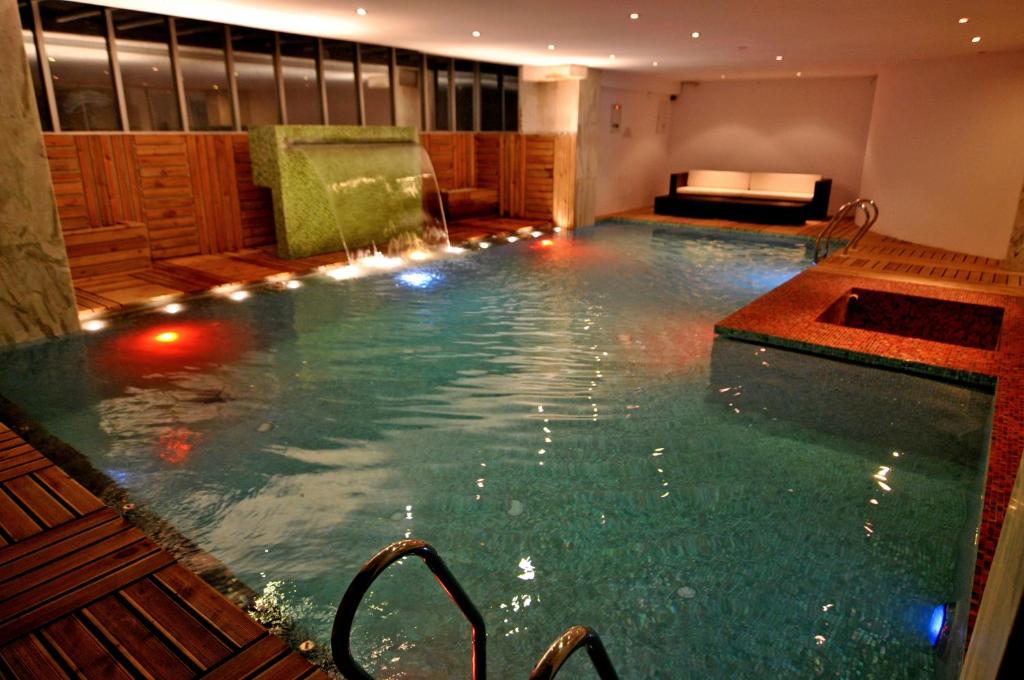 a swimming pool with a tub and a bathtub in it at Contemporary Heights Hotel and Apartments in Dhaka