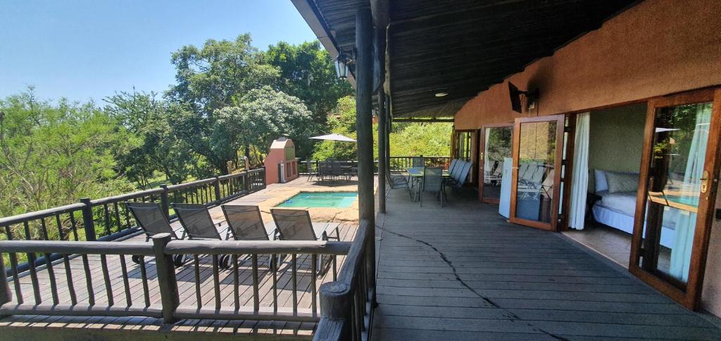 a porch of a house with chairs and a pool at DaGama Dam - White River - Kestrel - House 21 in White River