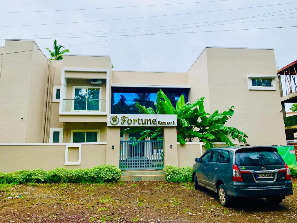 a car parked in front of a building at Fortune Resort in Nagaon