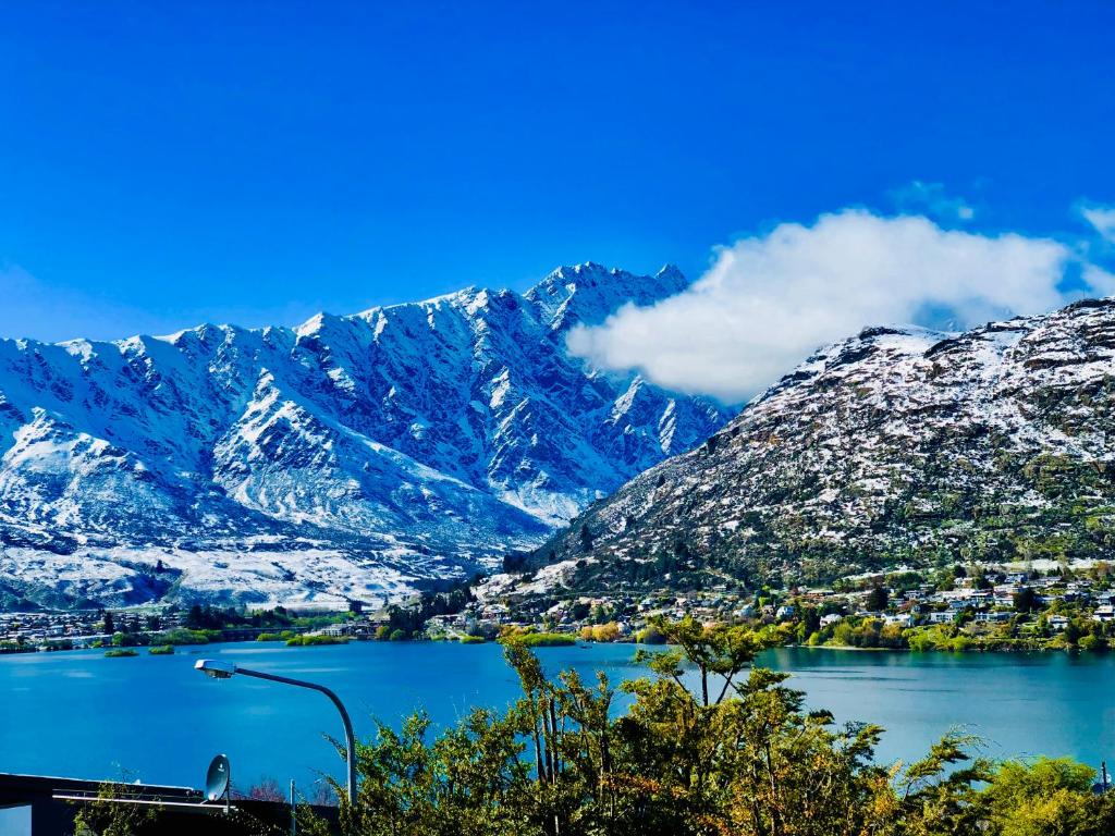 a view of a lake with snow covered mountains at Awesomely Cozy Queenstown Home with a View in Queenstown