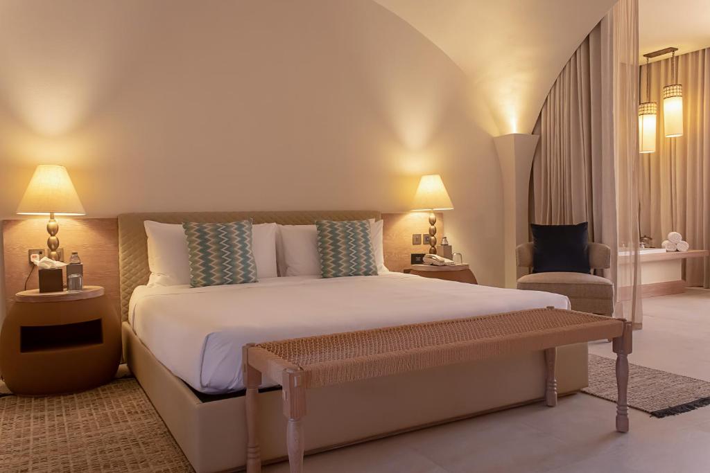
A bed or beds in a room at Liwa Hotel
