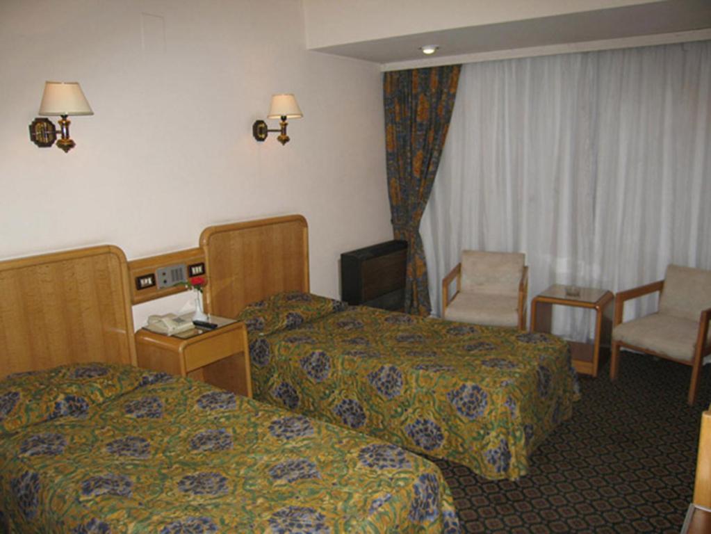 Postel nebo postele na pokoji v ubytování Philippe Luxor Hotel