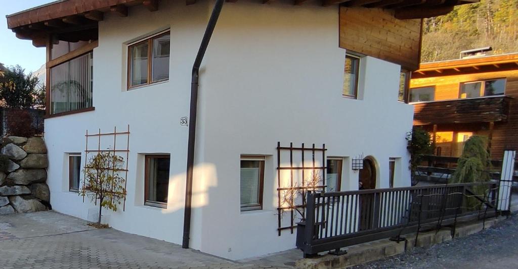 a white house with a porch and a balcony at Apartment Martina in Telfs