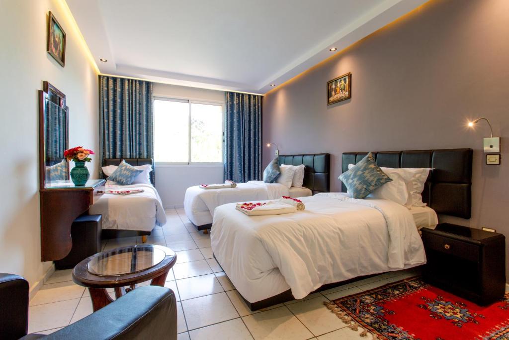 Postel nebo postele na pokoji v ubytování Hotel Akabar