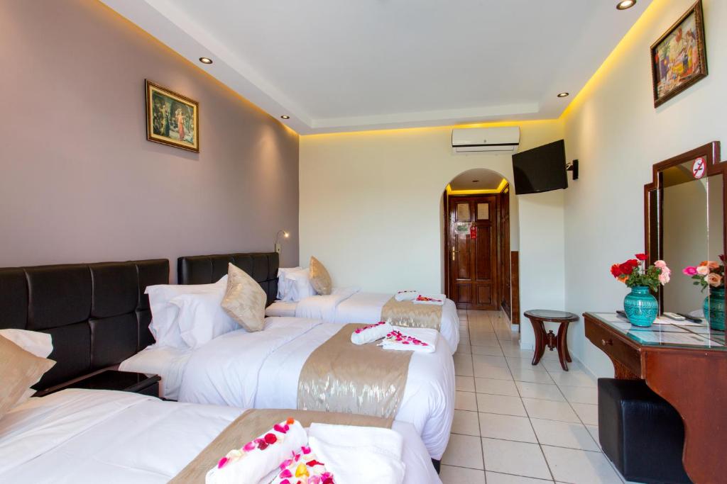 Postel nebo postele na pokoji v ubytování Hotel Akabar