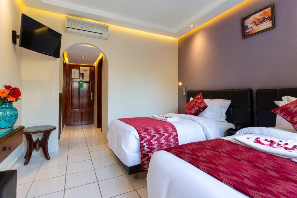 Postel nebo postele na pokoji v ubytování Hotel Akabar