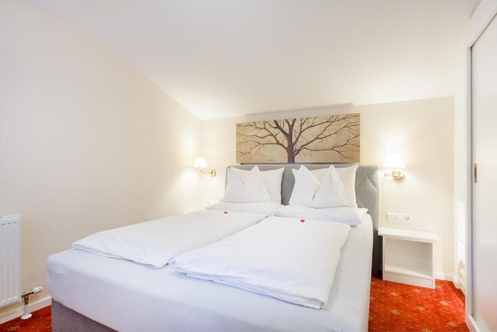 Postel nebo postele na pokoji v ubytování Hotel Garni Keil