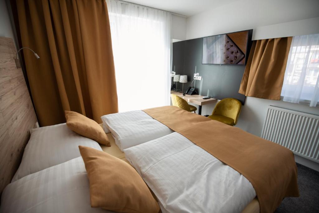 A bed or beds in a room at Primma Hotel