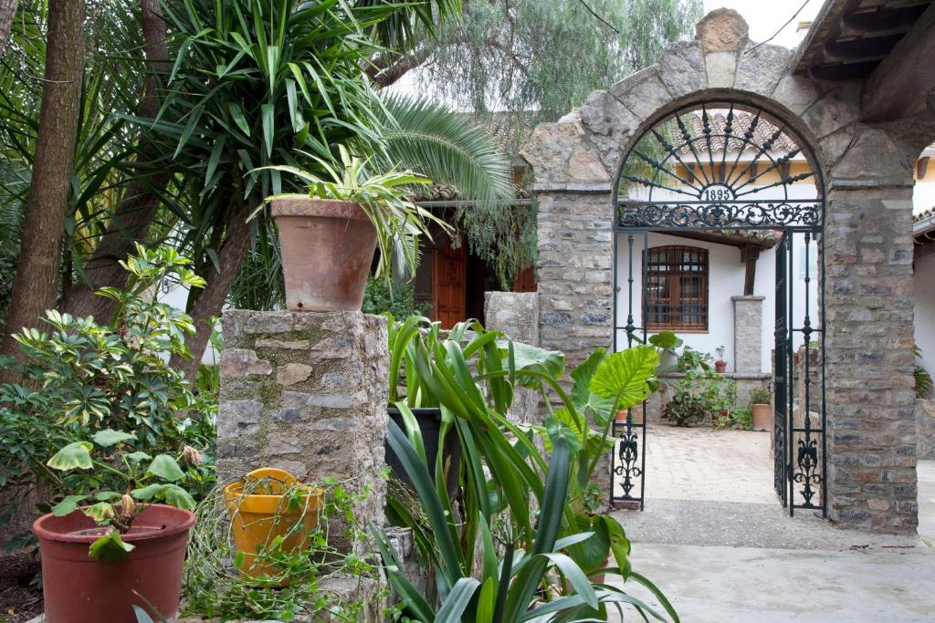an entrance to a house with plants and a gate at Hostal El Cortijo in Algodonales
