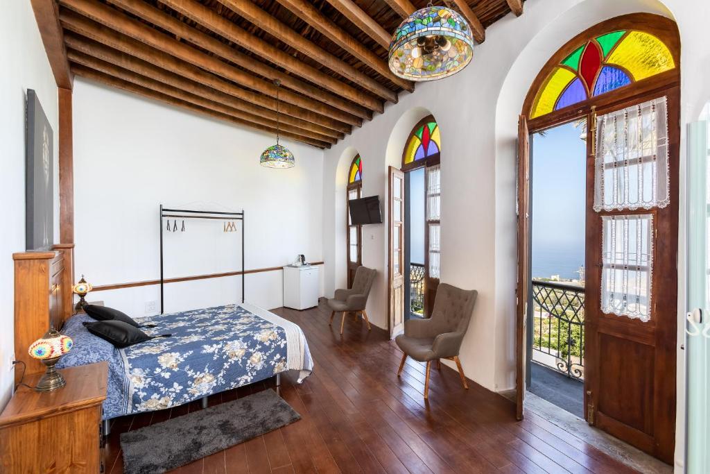 a bedroom with a bed and a balcony at ALOJAMIENTOS NECANA in Icod de los Vinos
