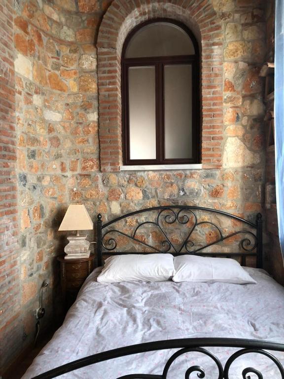 A bed or beds in a room at Lykos Mansion