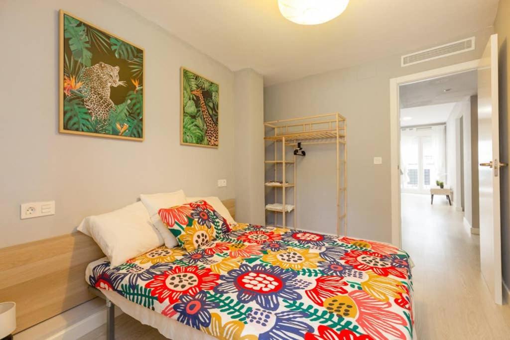 una camera con un letto con una coperta colorata di AGUSTINA - Piso céntrico reformado en calle peatonal a Saragozza
