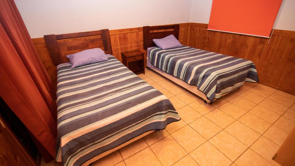 Postel nebo postele na pokoji v ubytování Cabañas Antulaf
