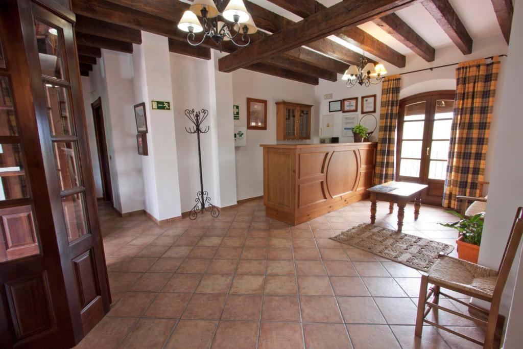 a large room with a hallway with a table at Hostal El Cortijo in Algodonales