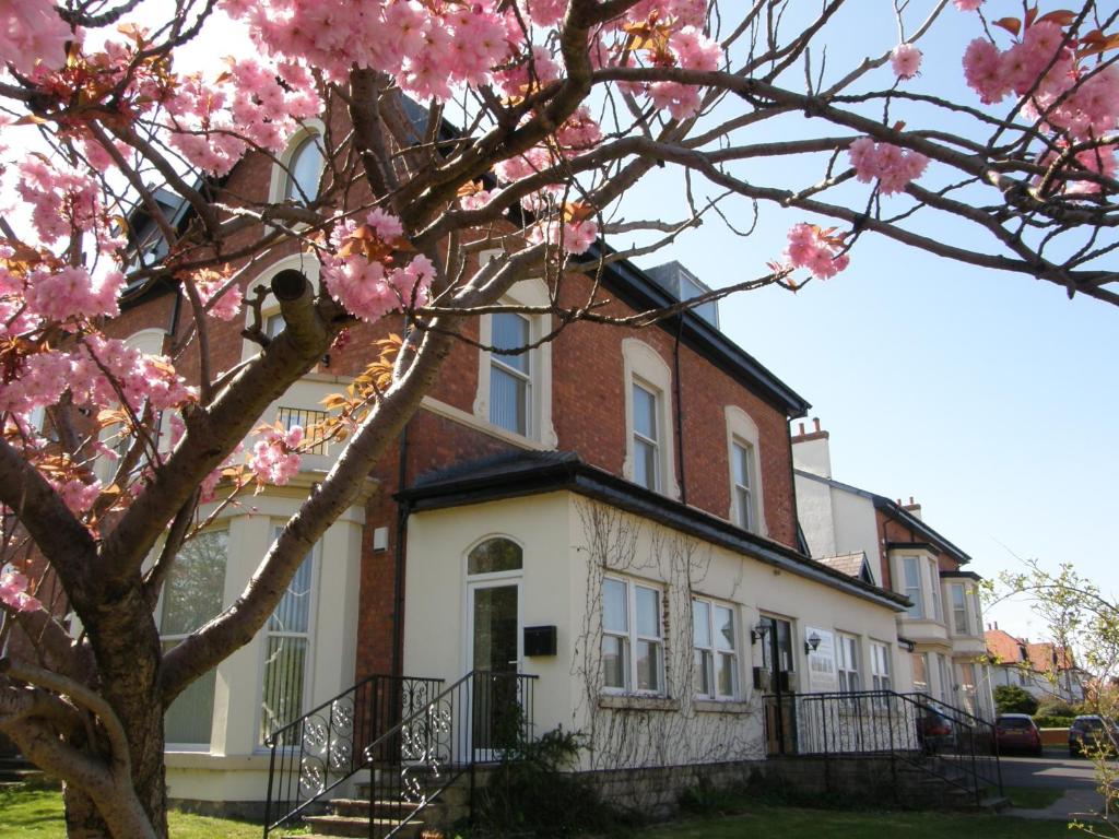 a house with pink flowers on a tree at The Shelbourne in Southport