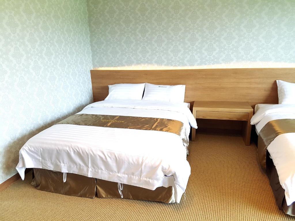 Postel nebo postele na pokoji v ubytování YangYang International Airport Hotel
