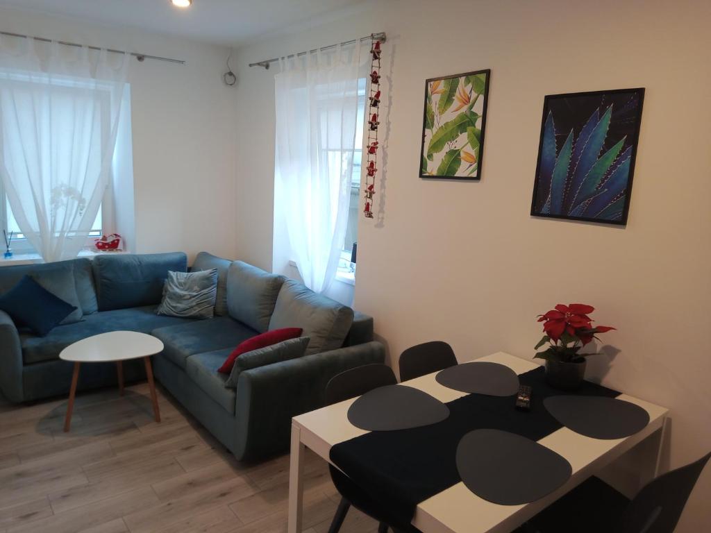 a living room with a couch and a table at Apartament na Zakręcie in Szklarska Poręba