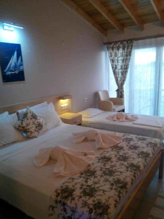 Postel nebo postele na pokoji v ubytování Mola Hotel