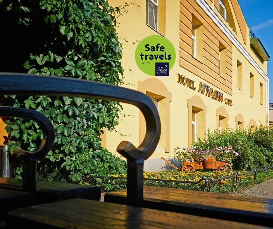 a bench in front of a building with a sign on it at Arkadia Hotel in Saint Petersburg