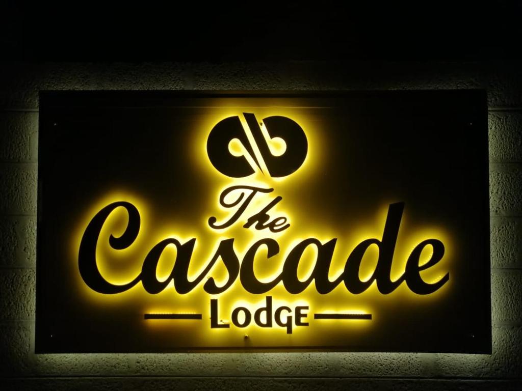 a neon sign for the casserole lodge at The Cascade Lodge in Embilipitiya