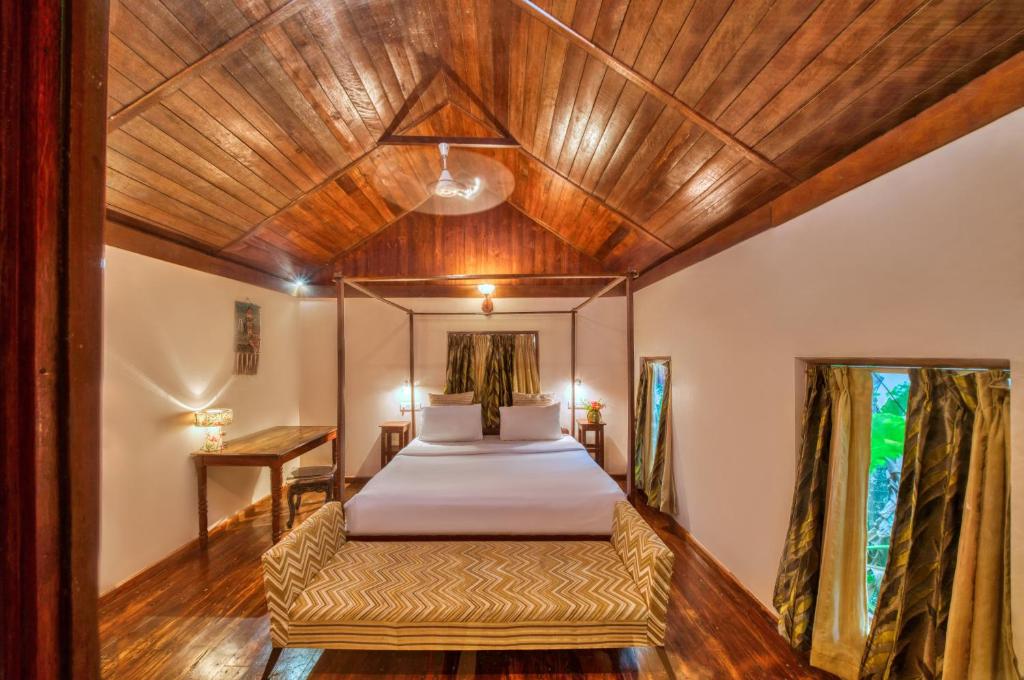 a bedroom with a bed and a wooden ceiling at Munjoh Ocean Resort - Private Beachfront Luxury Retreat in Havelock in Havelock Island
