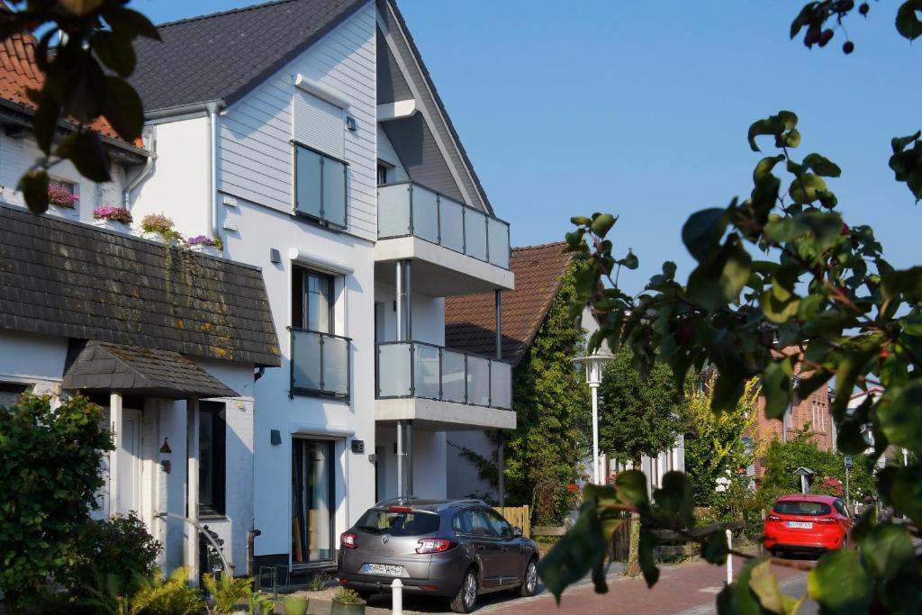 a house with a car parked in front of it at Deichresidenz Büsum in Büsum