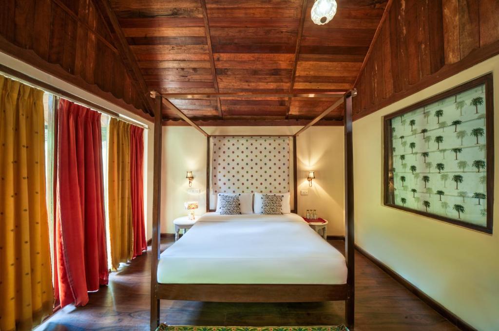 a bedroom with a canopy bed in a room at Munjoh Ocean Resort - Private Beachfront Luxury Retreat in Havelock in Havelock Island