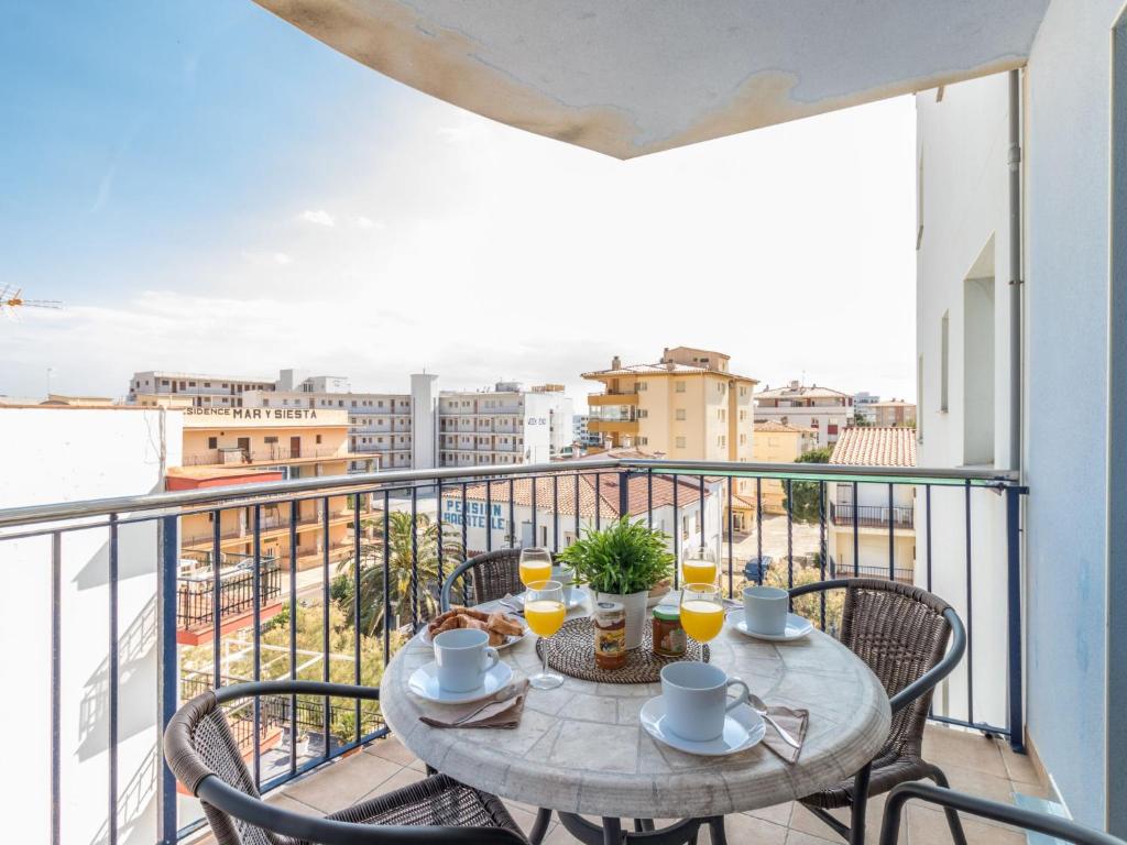 a table on a balcony with a view of a city at Apartment Nuvol Blau-3 by Interhome in Roses
