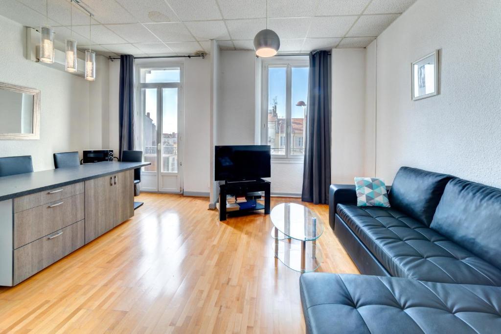 un salon avec un canapé et une télévision dans l'établissement IMMOGROOM - Charming apartment - City Center - Wifi - AC, à Cannes
